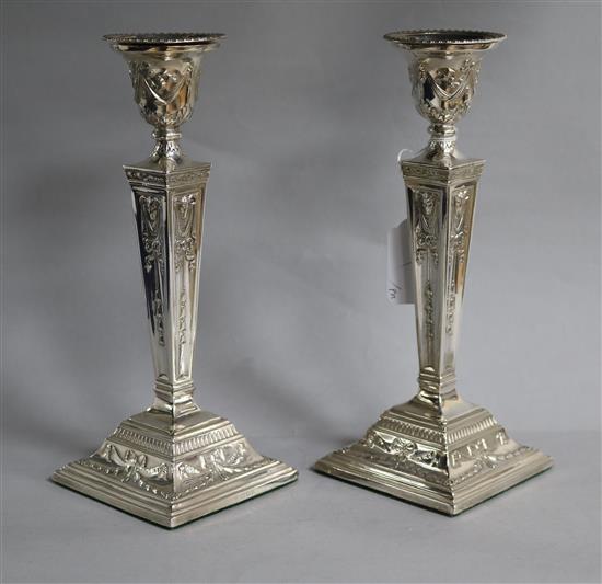 A pair of 1970s silver candlesticks with rams head and harebell decoration, D.J. Silver Repairs, London, 1970, weighted.